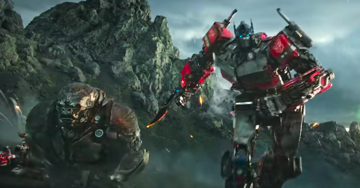Optimus Primal (a giant robot ape) and Optimus Prime (a giant robot truck) charge into battle in TRANSFORMERS: RISE OF THE BEASTS