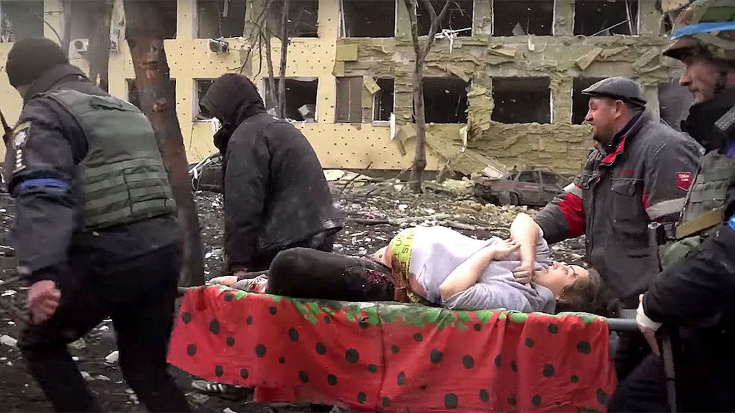 A wounded pregnant woman is carried on a stretcher after a hospital bombing in 20 DAYS IN MARIUPOL