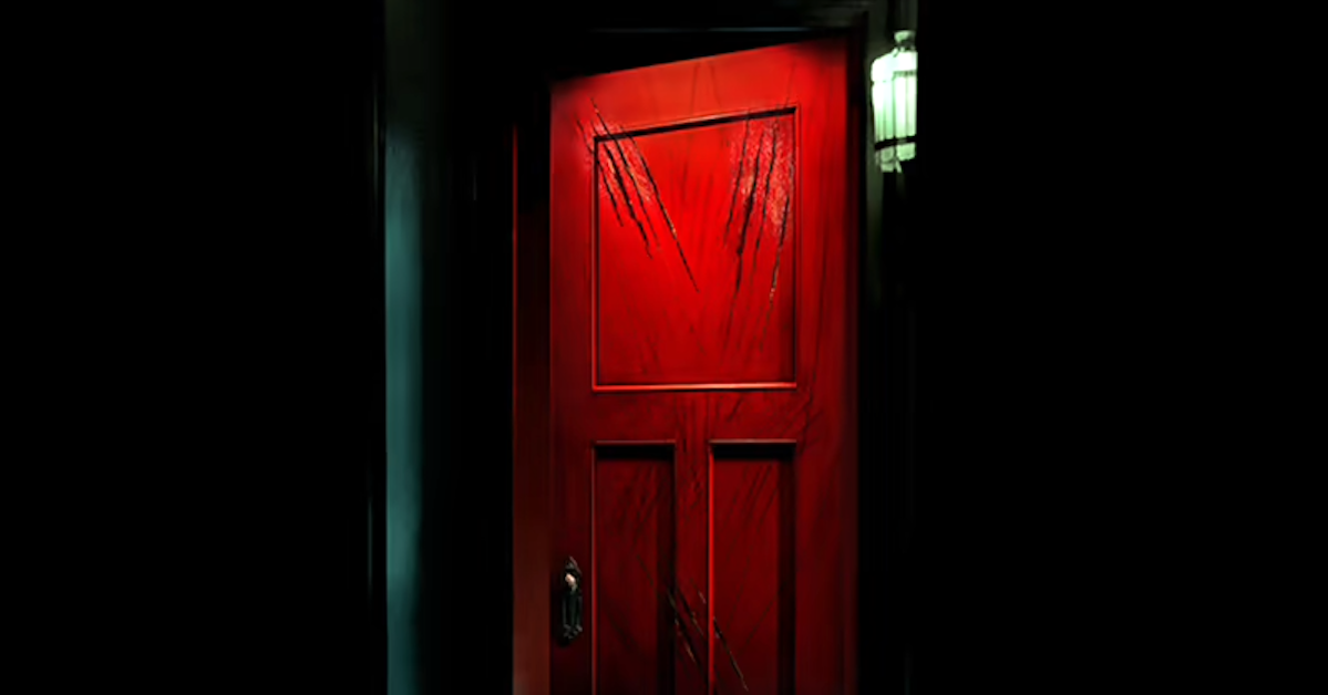 A red door, with claw marks on it, surrounded by a black space.